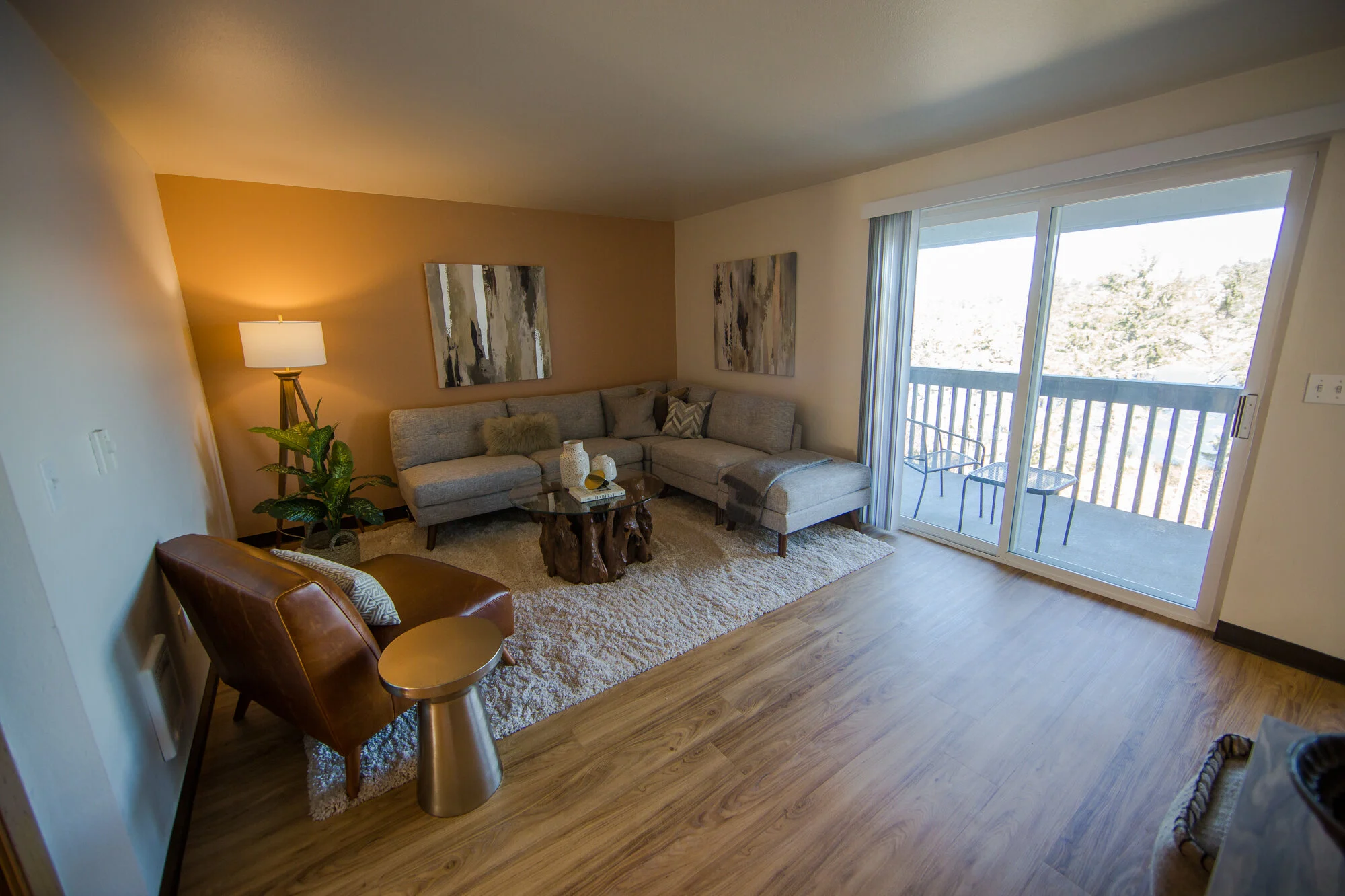 Staged living room with sliding balcony doors open to the view